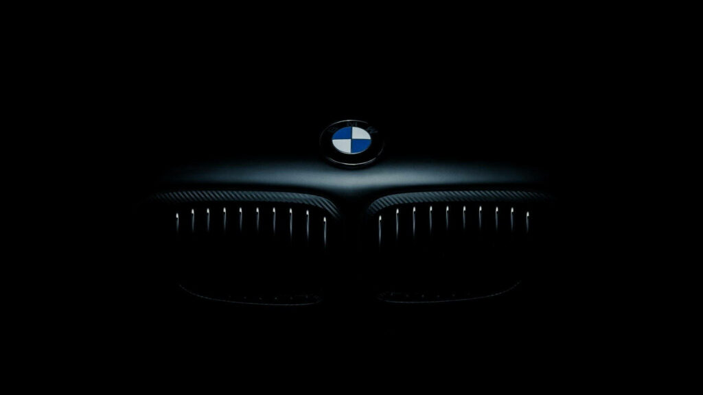 Night Riding: A BMW Laptop Wallpaper Featuring the Dazzling Headlight and Hood in a Dark Background
