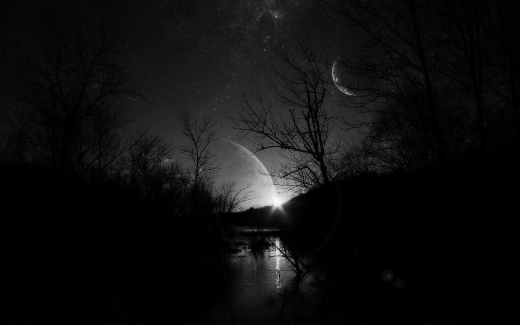 Black and white swamp silhouette with giant planet and crescent moon over calm reflective water wallpaper