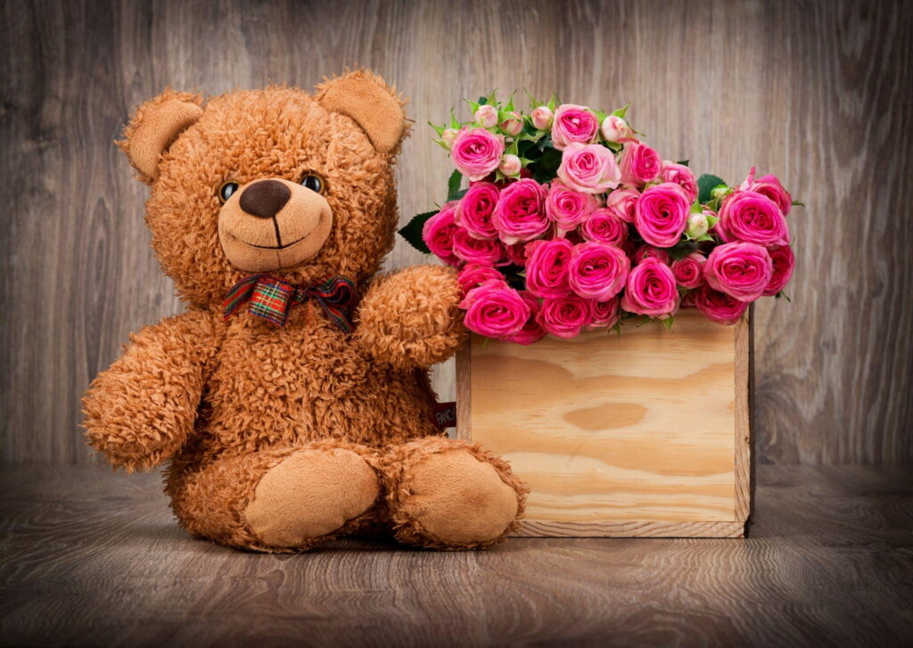 Teddy Love: Adorable Teddy Bear Surrounded by Pink Roses in a Box - QHD Wallpaper