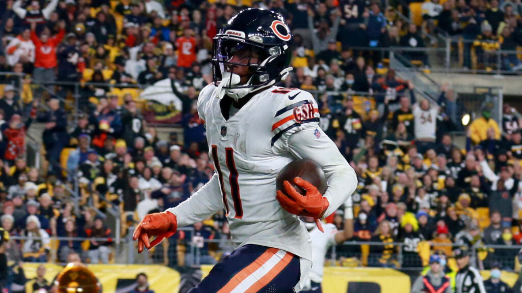 Darnell Mooney Chicago Bears white uniform clutching football vibrant stadium fans intense game Wallpaper