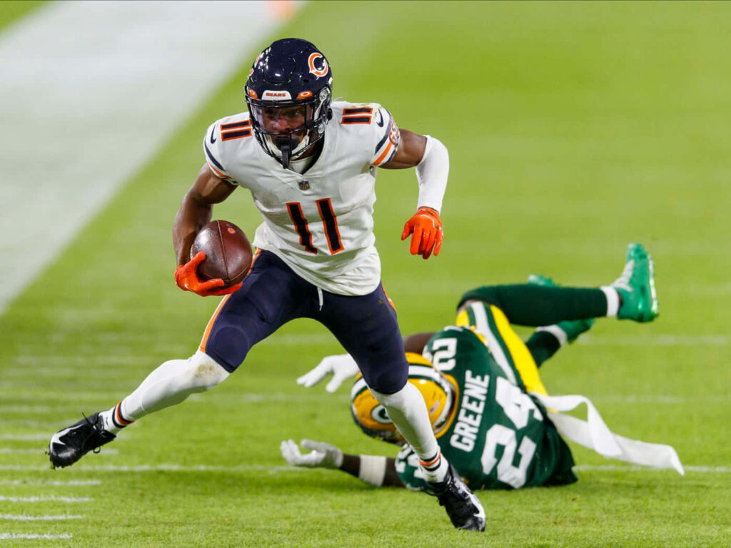 Darnell Mooney in white Chicago Bears uniform evades Packers defender sprinting on field wallpaper