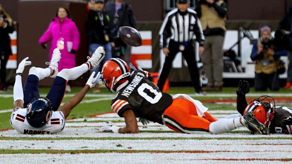 Darnell Mooney leaps for football in NFL game end zone action with vibrant team colors and crowd Wallpaper