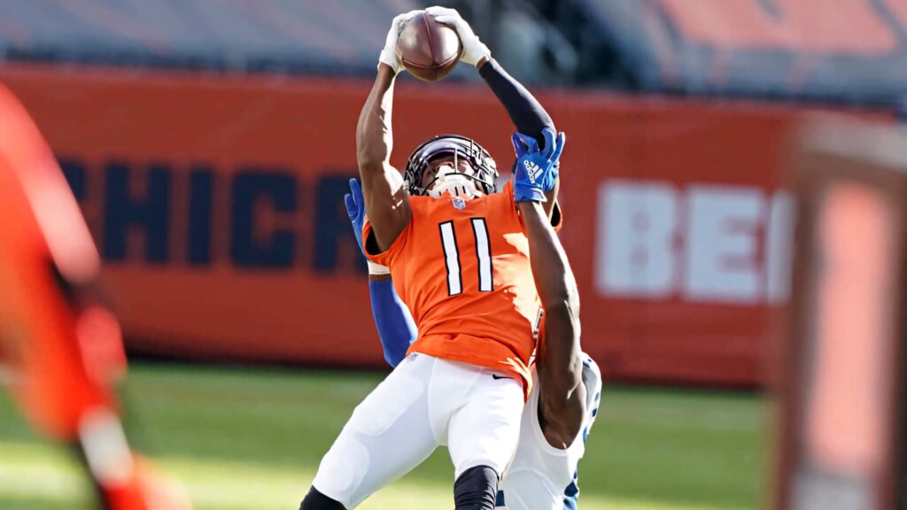 Darnell Mooney makes a high catch over defender in vibrant orange and navy football action wallpaper