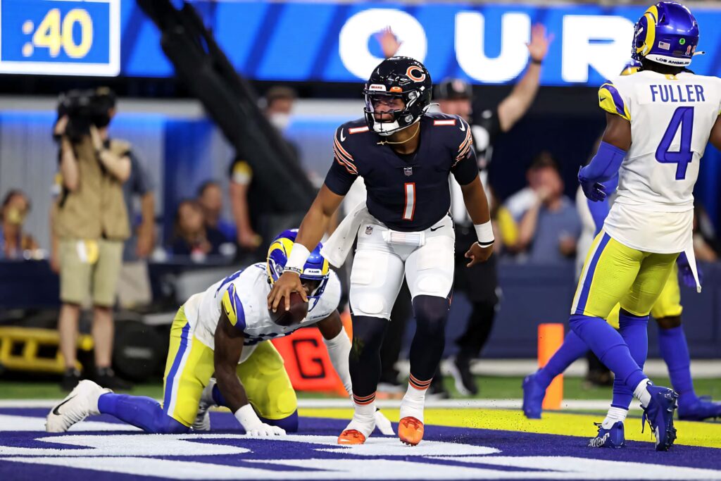 Darnell Mooney in Chicago Bears uniform celebrates touchdown against Rams in vibrant stadium lights Wallpaper