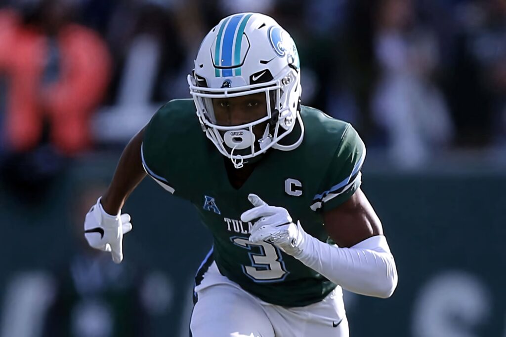 Darnell Mooney in green Tulane jersey mid-action football game intense focused energy lighting Wallpaper