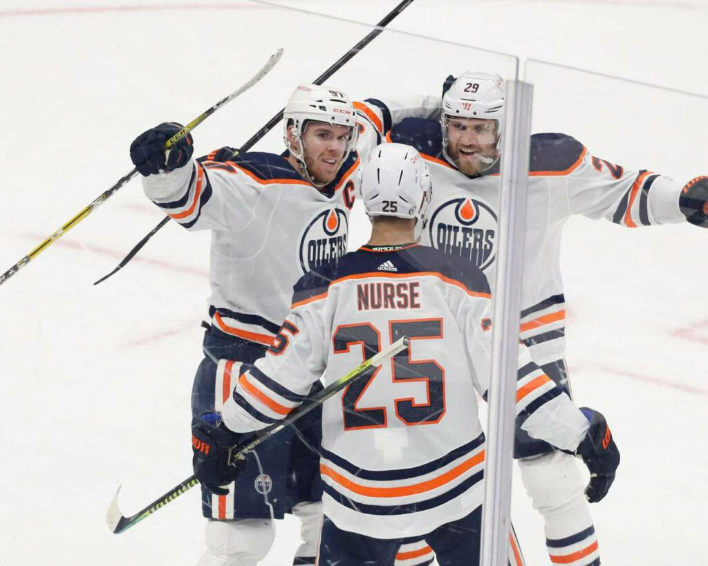 Darnell Nurse Edmonton Oilers celebrating with teammates in intense 2021 NHL game vs Maple Leafs Wallpaper