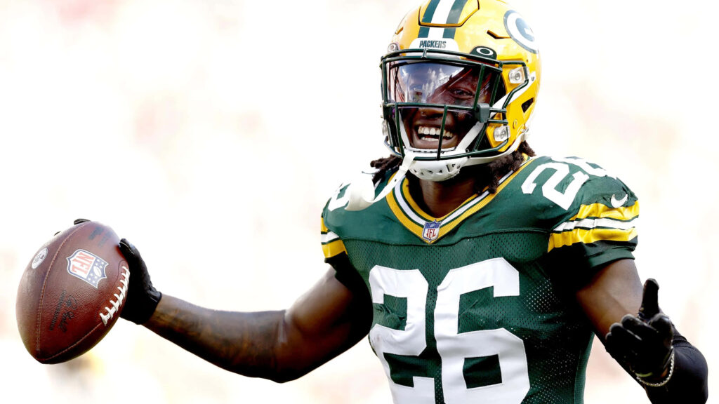 Darnell Savage Jr Green Bay Packers celebrating with football vibrant team colors dynamic wallpaper