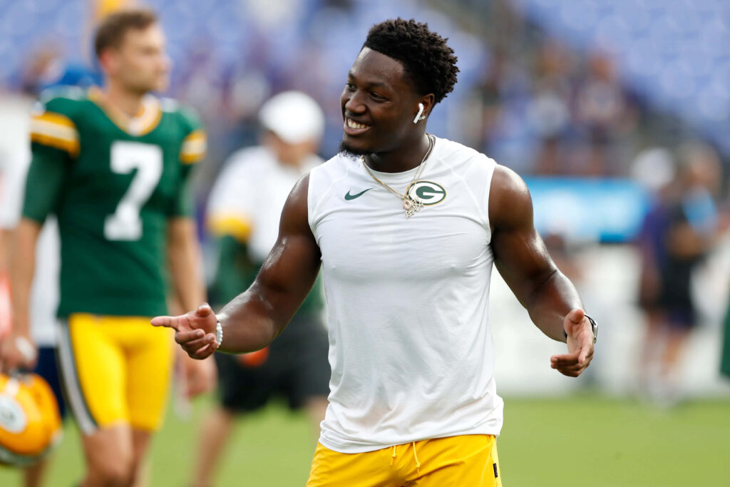 Darnell Savage Jr Green Bay Packers smiling during warmups in white sleeveless shirt and yellow shorts Wallpaper