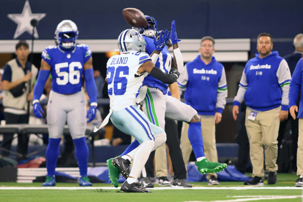Daron Bland number 26 defends fiercely against Seattle Seahawks in intense football play action Wallpaper