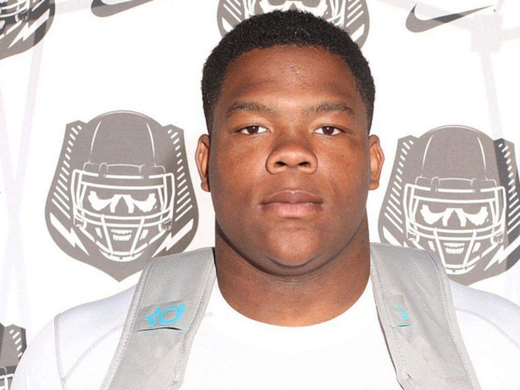 Daron Payne football player headshot with Nike logos and bold helmet graphics on white background Wallpaper