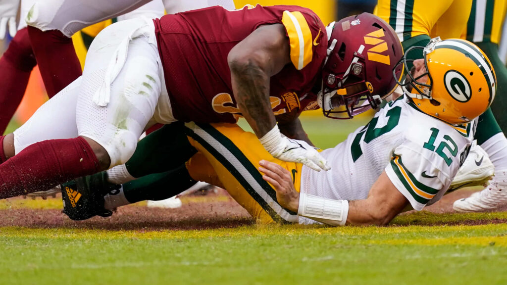 Daron Payne tackles Aaron Rodgers in vivid high definition Washington Commanders vs Packers game Wallpaper