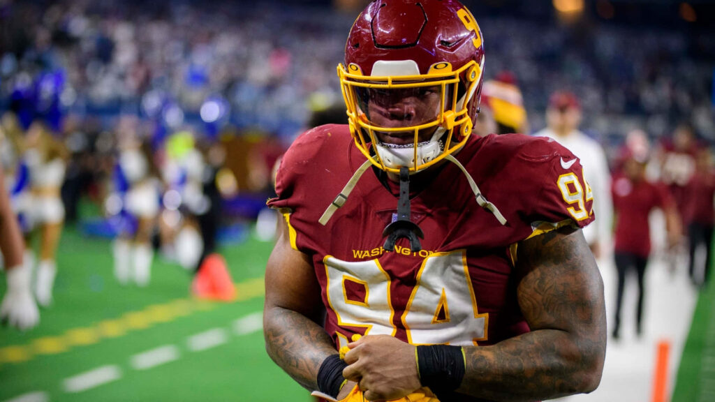 Daron Payne in Washington Commanders uniform number 94 focused during high-energy football game action Wallpaper