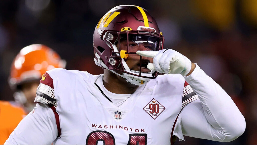Daron Payne Washington Football Team making bold gesture in maroon gold helmet white uniform Wallpaper