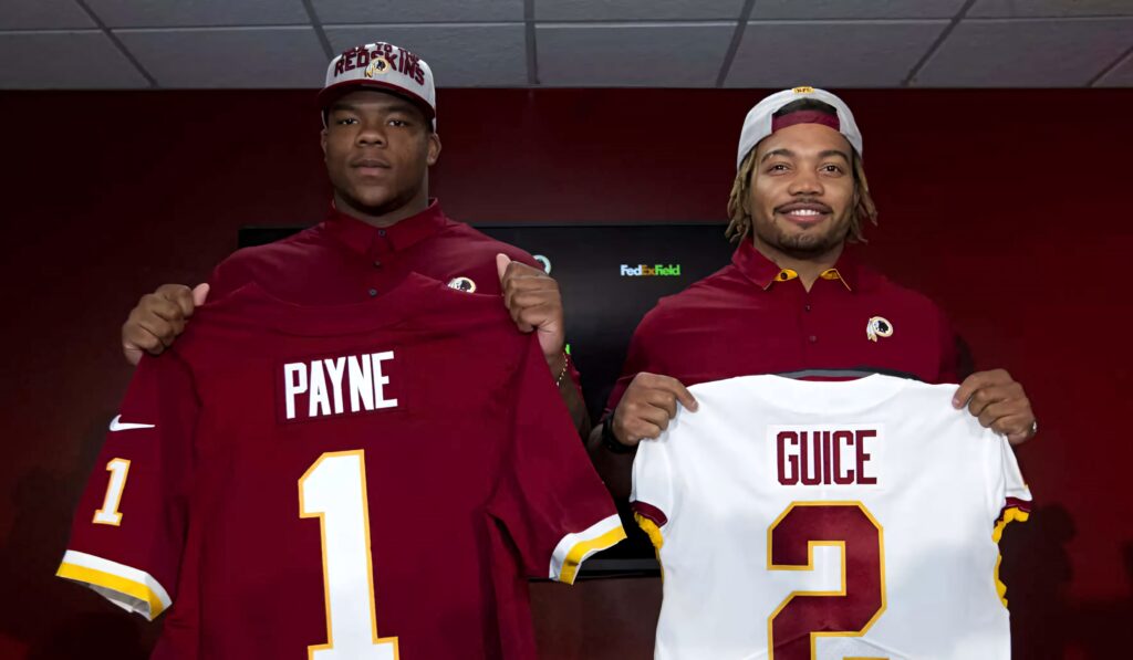 Daron Payne and Derrius Guice holding Washington Redskins jerseys in vibrant burgundy and gold wallpaper