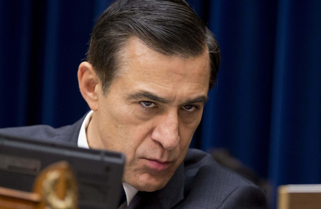 Darrell Issa intense close-up dark blue background stern authoritative expression wallpaper