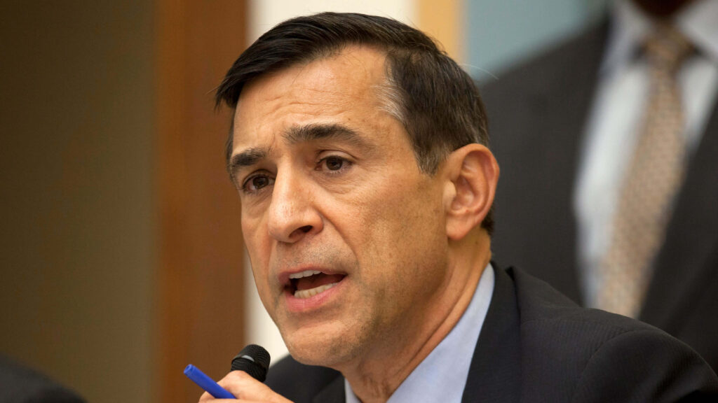 Darrell Issa speaking at event in formal attire with focused expression and blurred background Wallpaper