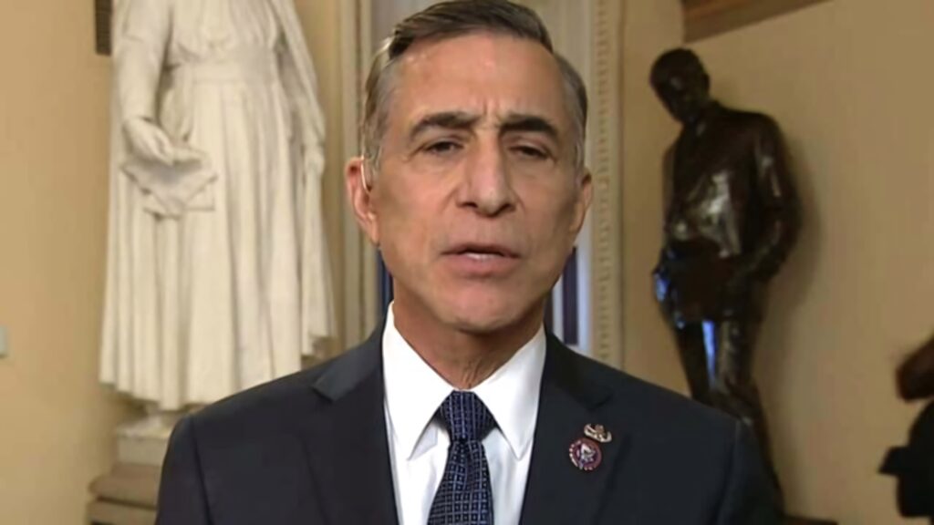Darrell Issa standing in historic formal room with statues and warm classic architectural lighting Wallpaper