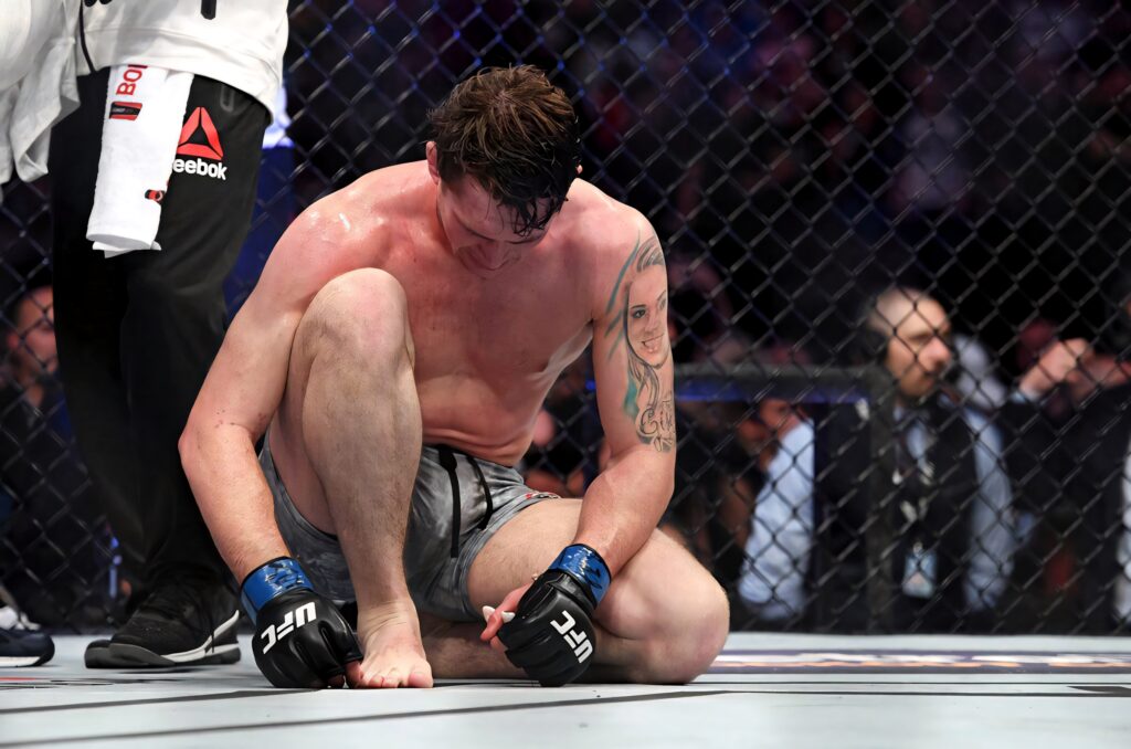 Darren Till exhausted on UFC octagon floor showing intense emotion and MMA energy wallpaper