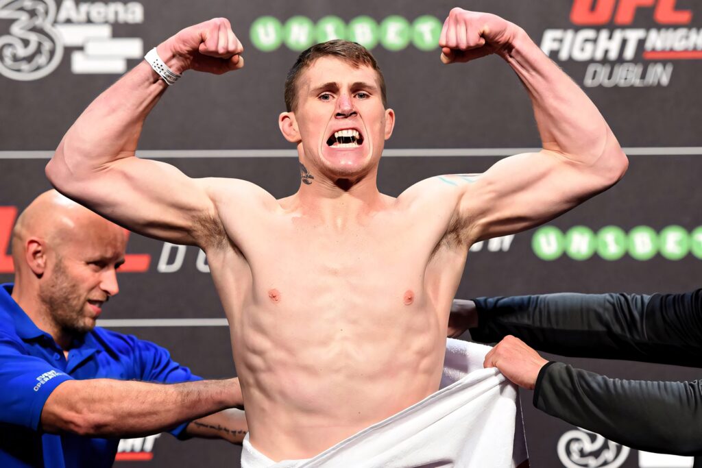 Darren Till flexes muscles with intense expression at UFC Fight Night Dublin weigh-ins backdrop Wallpaper