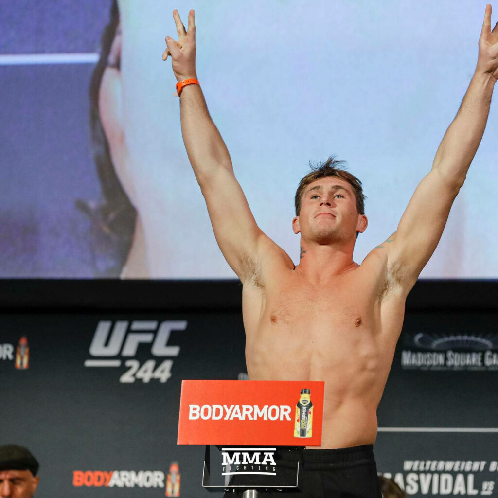Darren Till UFC 244 weigh-in pose arms raised athletic physique MMA arena background wallpaper