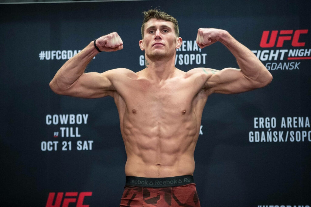 Darren Till flexes muscles confidently at UFC Gdansk weigh-in showcasing athletic physique Wallpaper