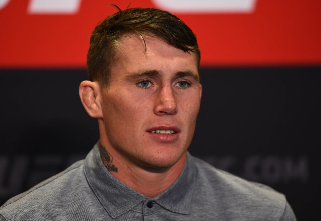 Darren Till serious UFC press conference gray shirt red and black backdrop intense focus Wallpaper