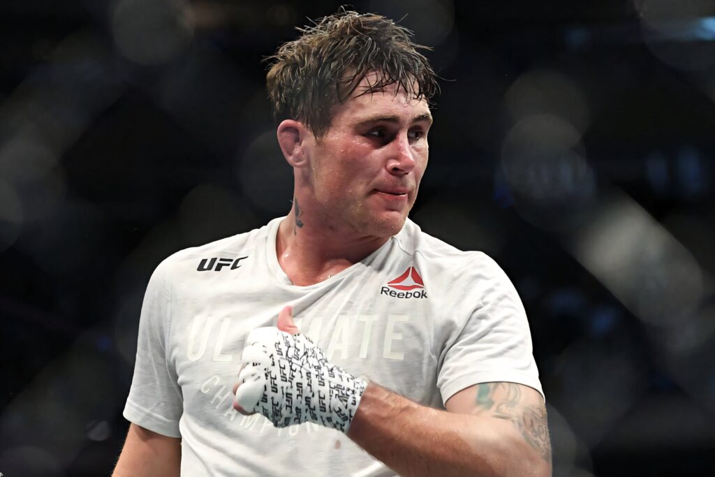 Darren Till UFC wallpaper intense expression white shirt signed hand wraps dramatic arena background