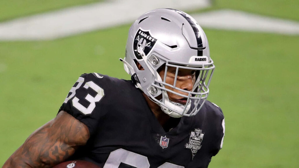 Darren Waller Raiders action shot intense athleticism black silver uniform stadium backdrop wallpaper