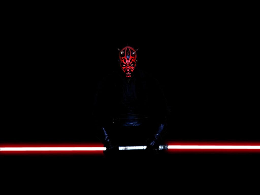Darth Maul with glowing double-bladed red lightsaber dark intense Sith Lord wallpaper