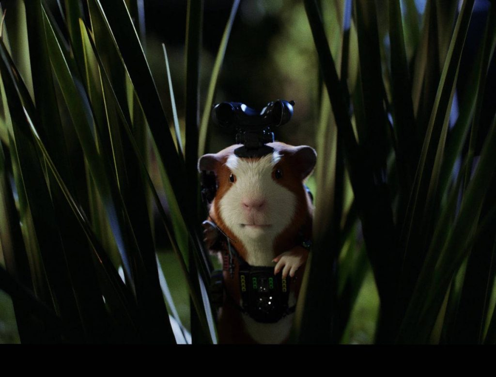 Darwin from G Force in tactical gear peering through green grass cinematic wallpaper