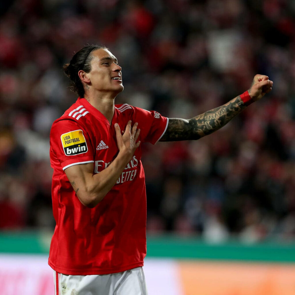 Darwin Núñez celebrates with hand heart in red Benfica jersey at vibrant packed football stadium Wallpaper