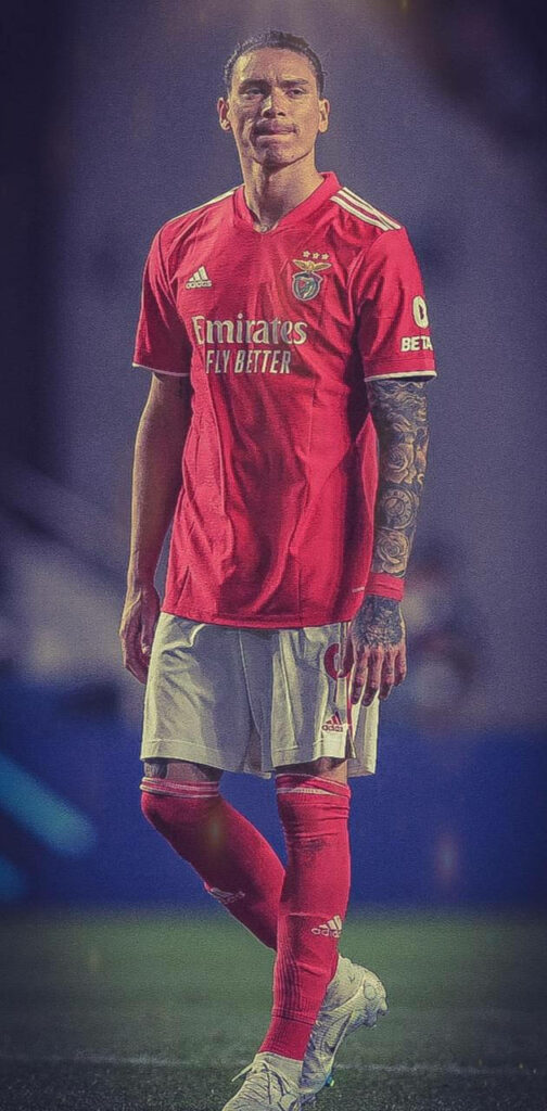 Darwin Núñez in red Benfica kit with tattoo sleeve under dramatic lighting football wallpaper