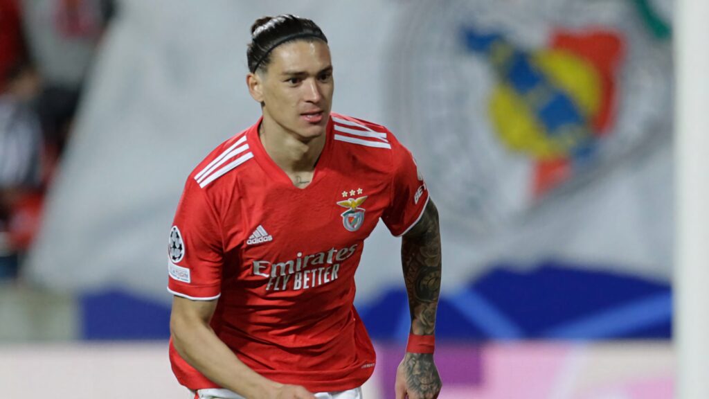 Darwin Núñez running in vibrant red Benfica kit with club crest blurred background football energy Wallpaper