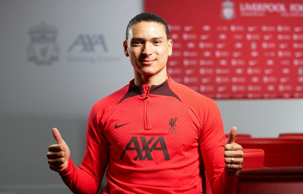 Darwin Núñez in red Liverpool training kit celebrating victory with double thumbs up backdrop Wallpaper