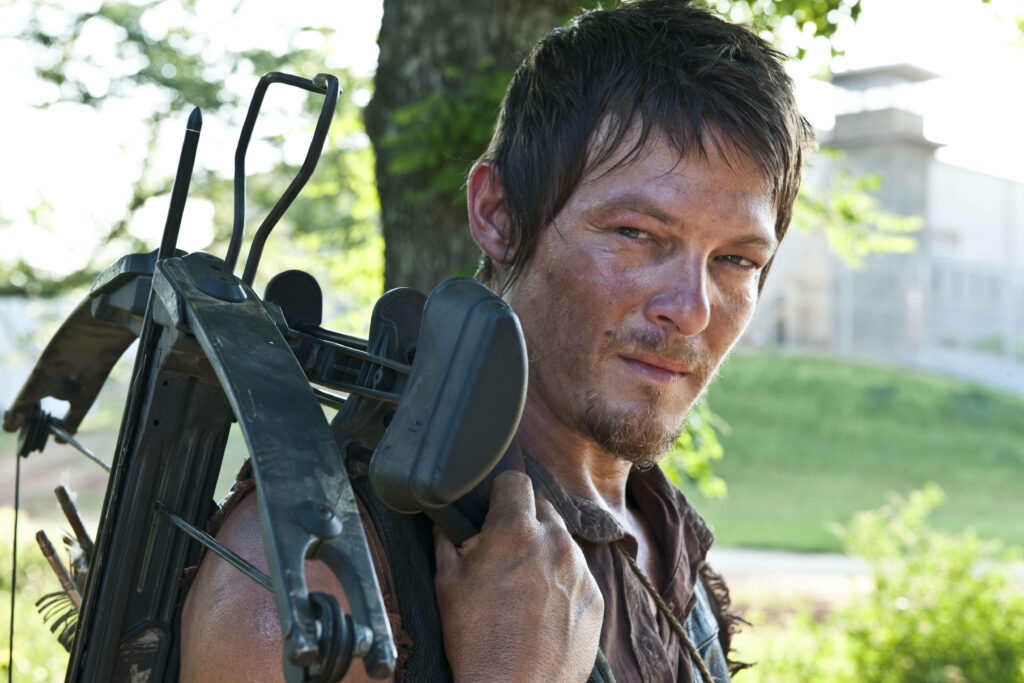 Daryl Dixon Wallpaper: Iconic Crossbow Scene in Lush Green