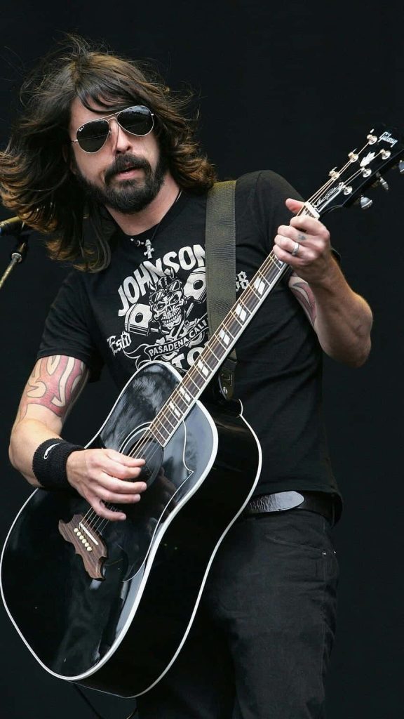 Dave Grohl live performing with Gibson acoustic guitar in aviators and graphic tee wallpaper
