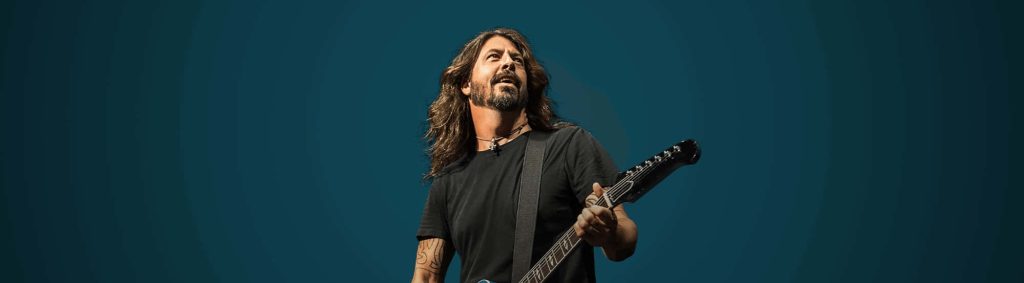 Dave Grohl Foo Fighters live rock performance electric guitar dynamic teal background wallpaper
