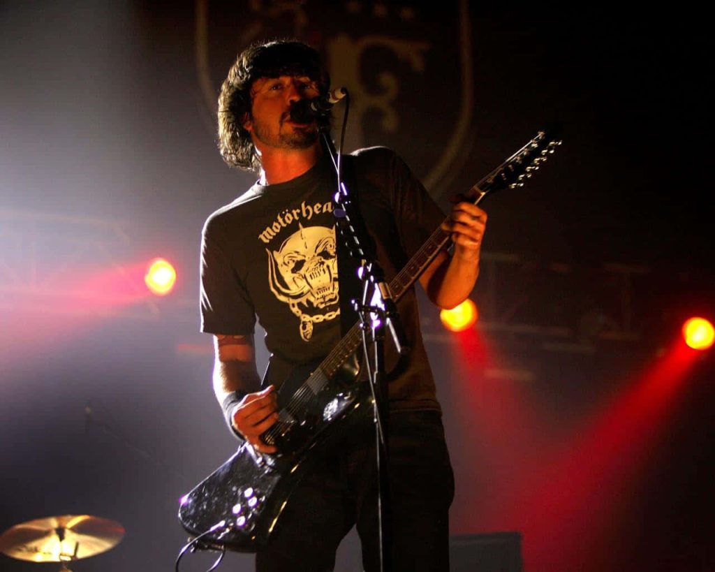 Dave Grohl performing live in Motörhead shirt electric guitar energetic concert wallpaper background