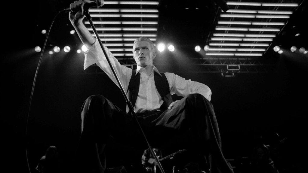 David Bowie performing live at Royal Albert Hall under bright stage lights dramatic concert moment Wallpaper