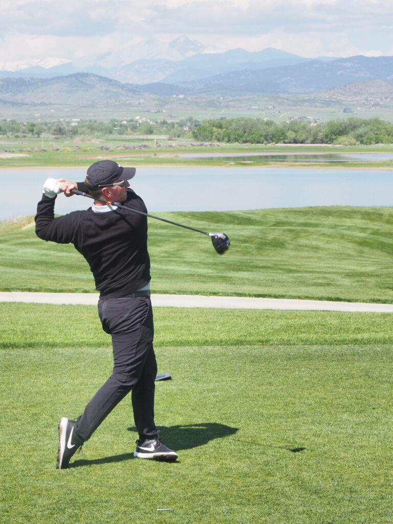 David Duval mid golf swing on green course with lake and mountains vibrant nature wallpaper