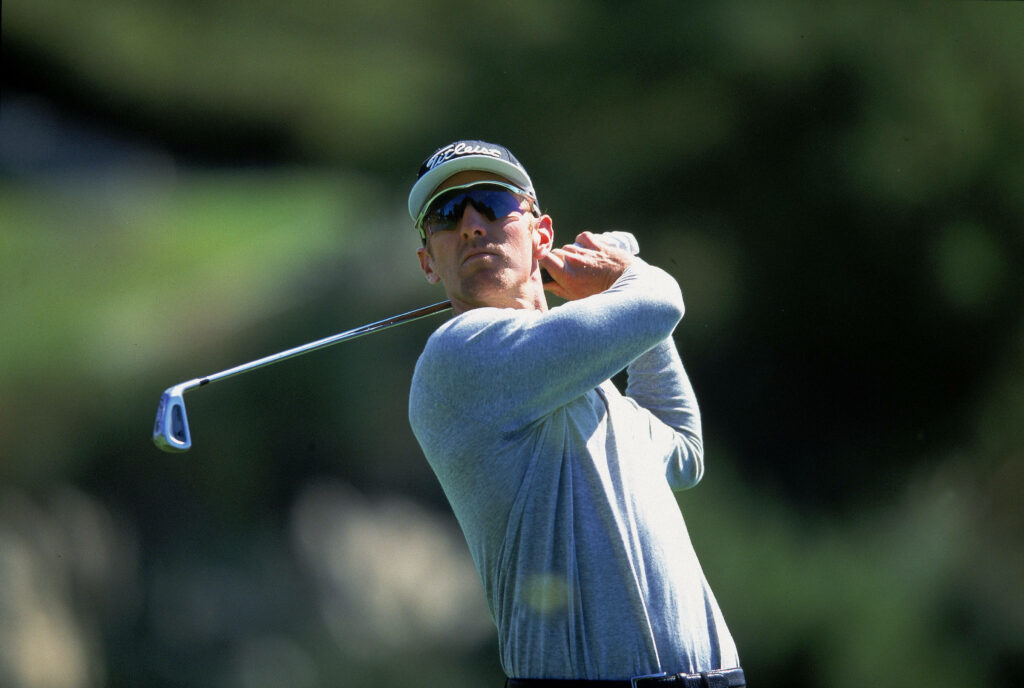 David Duval mid-swing on golf course vibrant greens soft sunlight dynamic serene sports wallpaper background