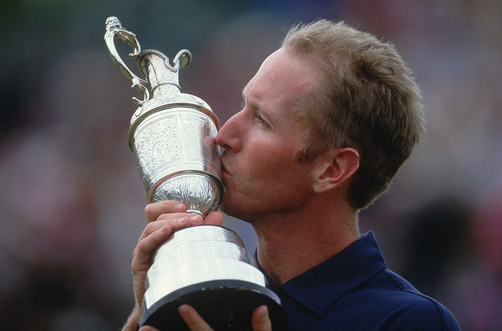 David Duval kissing ornate silver trophy close-up celebrates golf victory classic sports wallpaper