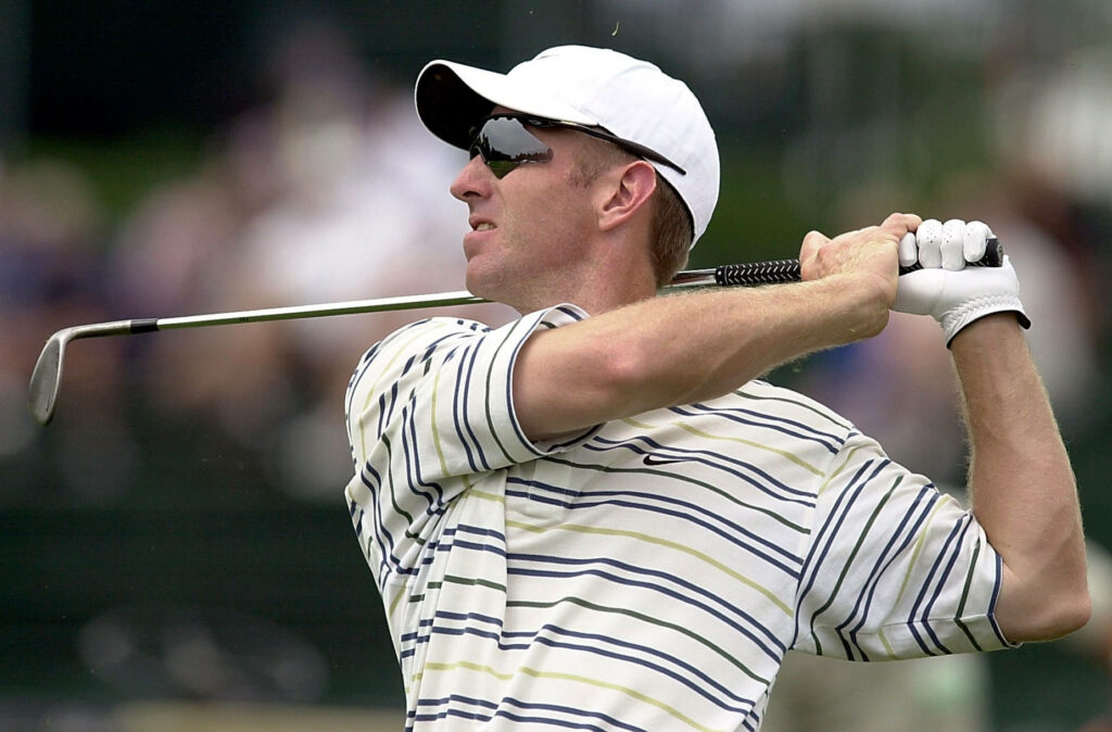 David Duval mid-swing golf wallpaper young athlete striped shirt white cap dark sunglasses