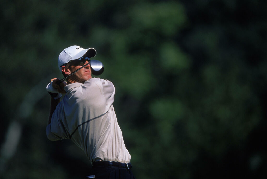David Duval mid golf swing sharp clarity deep green background dynamic golf action wallpaper