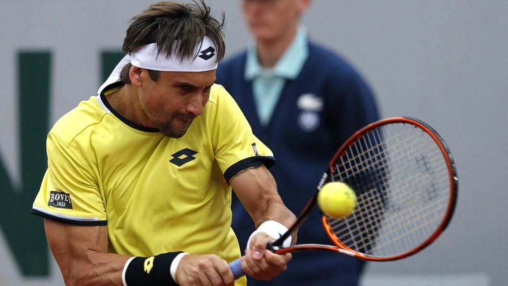 David Ferrer in vibrant yellow tennis outfit executing a dynamic double hand stroke on court Wallpaper