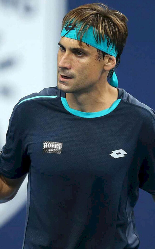 David Ferrer in navy blue sportswear focused during tennis match action wallpaper background