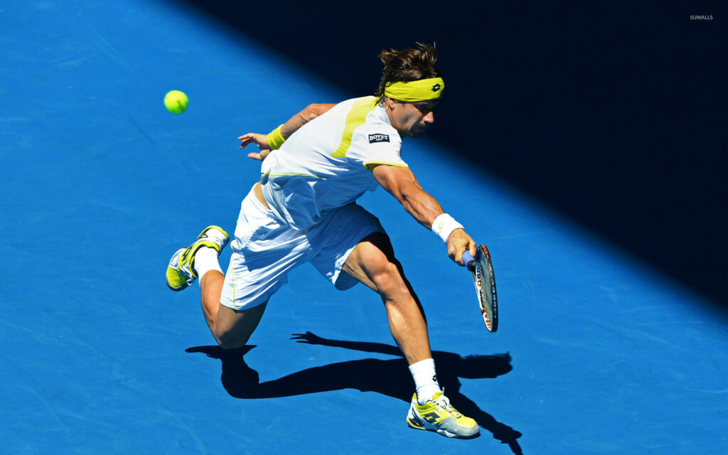 David Ferrer lunges for tennis ball on bright blue court showcasing intense professional tennis action Wallpaper