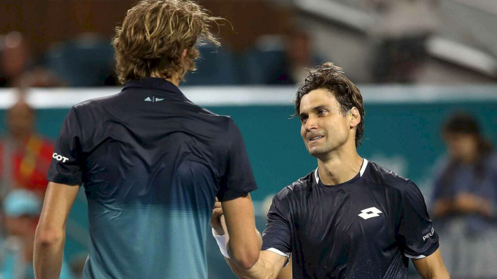 David Ferrer and opponent shake hands at net showing sportsmanship on vibrant tennis court crowd background Wallpaper