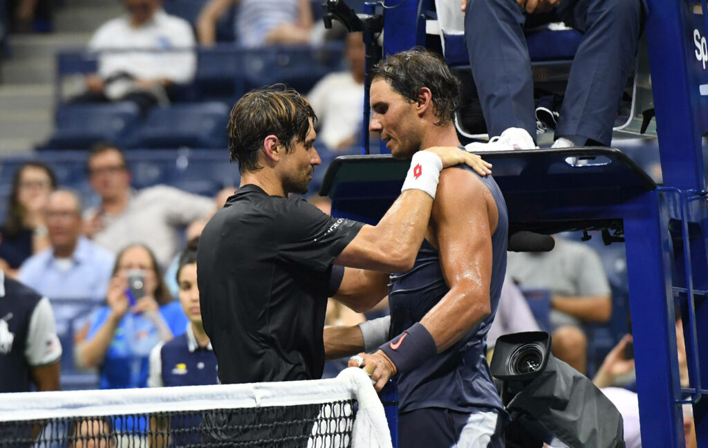 David Ferrer and Rafael Nadal show sportsmanship and respect after intense tennis match in stadium Wallpaper