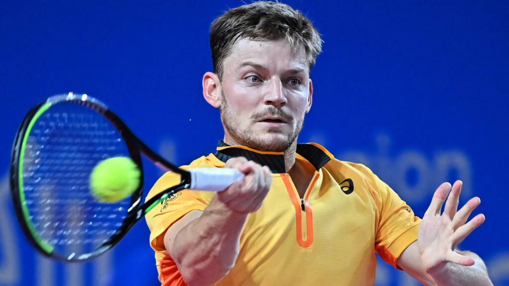 David Goffin intense tennis shot orange outfit vibrant sports wallpaper background action pose